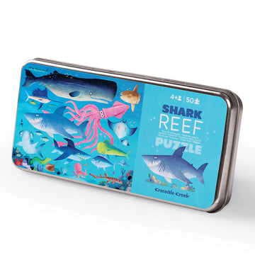 A tin with an illustration of different sharks swimming and the title 'Shark Reef'.