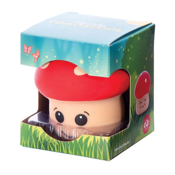 A squishy toadstool toy inside a box with a large cut out on the front.