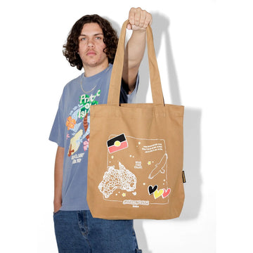 A caramel coloured tote bag with illustrations of Australia, the Aboriginal flag, hearts and an eagle.