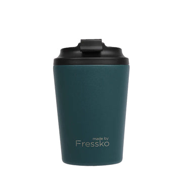 A reusable coffee cup in a dark emerald green with a black lid and the text 'made by Fressko' on the bottom.