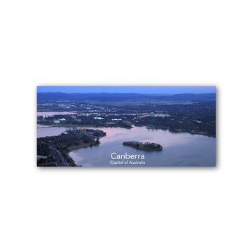 Aerial view of Canberra with a lake and island, labeled as the capital of Australia.
