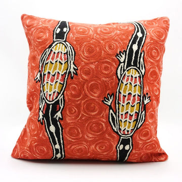 Decorative pillow with animal design on a red background.