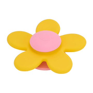 A baby silicone toy shaped like a  flower than spins.