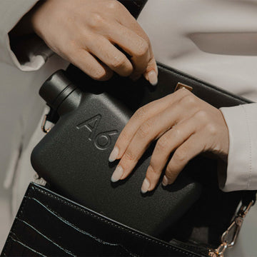 A flat black bottle with the text 'A6' on the top right corner.