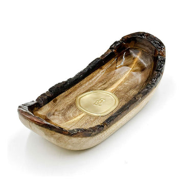 Wooden bowl with a gold emblem on a white background.