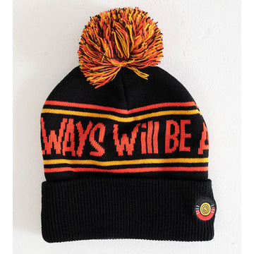 A black knitted beanie with the text 'Always Will Be' written around it and an orange, black and yellow pom pom on top.