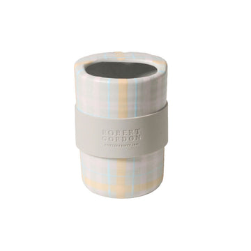 A ceramic travel mug with a pastel plaid design.
