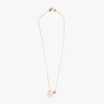 A fine gold chain with a light pink resin bead pendant.