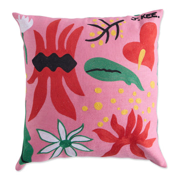 Front view of an pink cushion embroidered with green and red flower and leaf motifs.