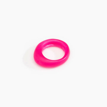 A pink resin ring with a rounded triangular edge at the front.