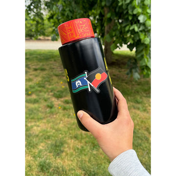 A sticker of both the Aboriginal and Torres Strait Islander flags on a black information card.