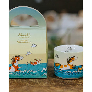 A child's mug with an illustration of a pong in water.