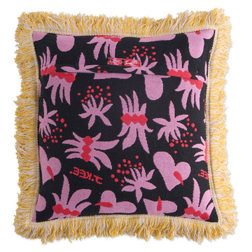 Front view of a woven cushion printed with red floral and heart motifs with a yellow tassel edge.