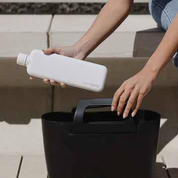 A slim flat water bottle in white.