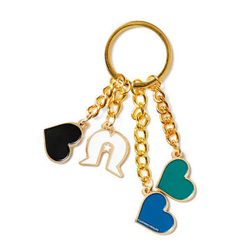 A keyring with four charms attached to a black card.