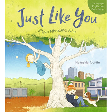 'Just Like You' book cover featuring an illustration of two children hanging around the tree with houses and buildings in the background.