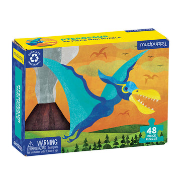 A puzzle box featuring an illustration of a blue pterosaur flying in front of a volcano.