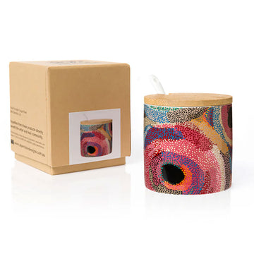 A sugar bowl printed with artwork by Marianne Burton with a wooden lid and white spoon sticking out the side. There is a brown box next to the bowl.