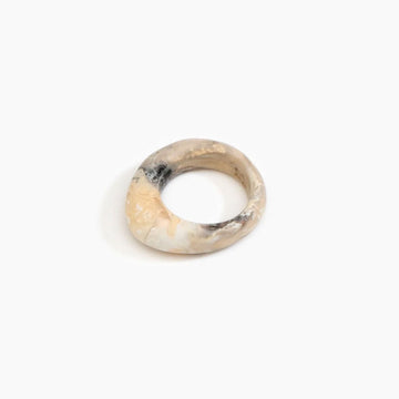 A light brown resin ring with a rounded triangular edge at the front.