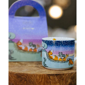 A child's mug with an illustration of a cat sitting on a pony.