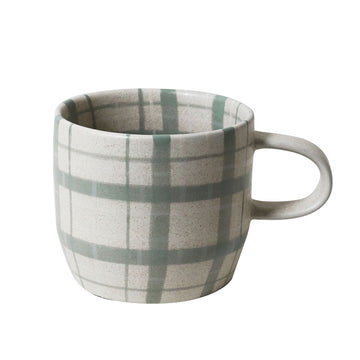 Green plaid patterned mug on a white background.