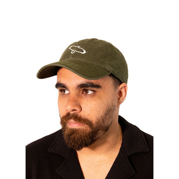Close up front view of a man wearing a khaki coloured cap with a line drawing of an eagle.
