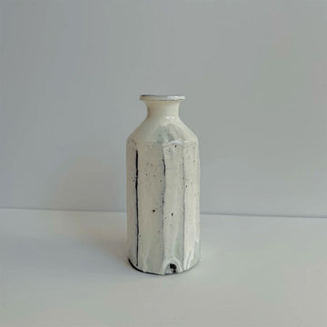 A ceramic handmade vase with a hexagon style shape.