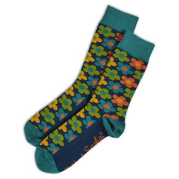 A pair of dark green socks printed with blue, orange and orange flowers.
