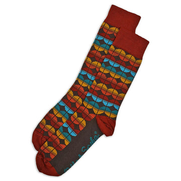A pair of dark red socks printed with a pattern in orange and blue.