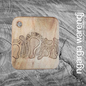 A square wooden board with an etch drawing of a snake design.
