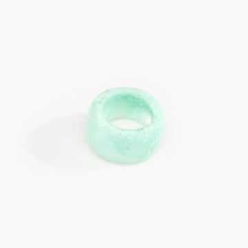 A resin ring in mint green with a wide band.