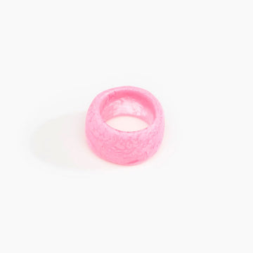 A resin ring in pink with a wide band.