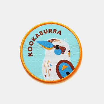 A round woven patch with an embroidered kookaburra design.