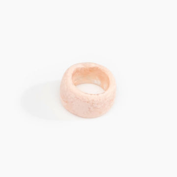 A resin ring in light pink with a wide band.