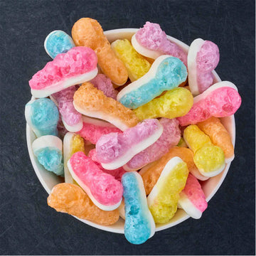 A bag of freeze dried lollies with lollies around the bag.