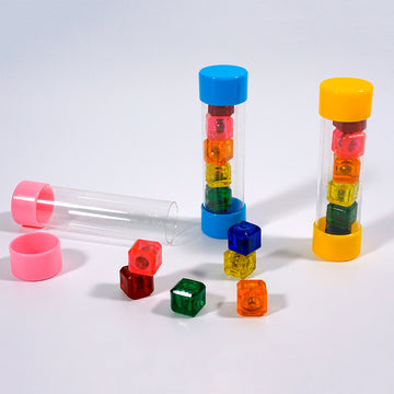 Colorful plastic blocks in transparent tubes on a white background.