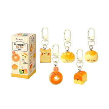 Five different bakery themed keyrings with animal designs next to a packaging box.
