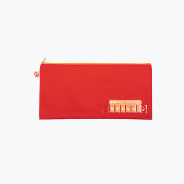 A red pencil case with a clear spot in the bottom corner to fill with letters for a name.