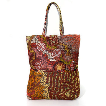 A quilted style tote baby bag printed with Indigenous artwork in shades of brown.