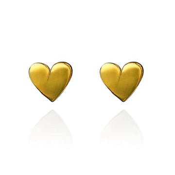 A pair of heart shaped stud earrings in gold.