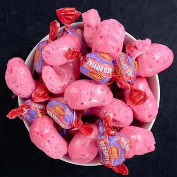 Packaging of freeze-dried lollies with pink lollies on a purple background