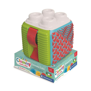 A baby toy shaped like a cube with different textured sides on a shallow box with product information.