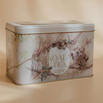 A rectangle tin with the heading 'Koala Tea' on the front with illustrations of birds and koalas in trees.