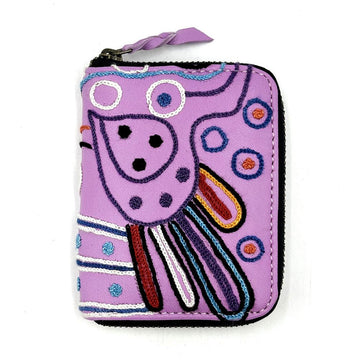 A zippered wallet in purple with embroidered details.