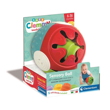 A baby toy in the shape of a ball with sensory elements attached to card packaging.