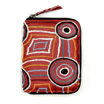 A zippered wallet in red with embroidered details.