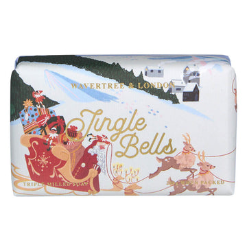 A bar of soap wrapped up in packaging with the text 'Jingle Bells' and an illustration of Santa in his sleigh with presents, elves and reindeer.