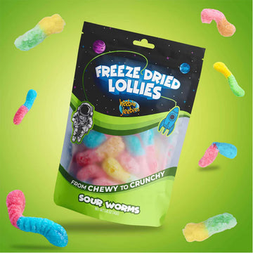 Packaging of freeze-dried lollies with colorful sour worms on a green background.