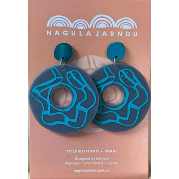 Blue round drop earrings with an etching of a snake on a 'Nagula Jarndu' branded card.