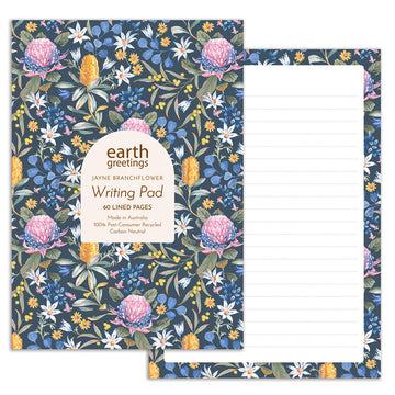 Front and page view of a writing pad. The front is illustrated with pink, blue and yellow flowers including waratahs and wattle. The writing page is lined with a matching floral border.